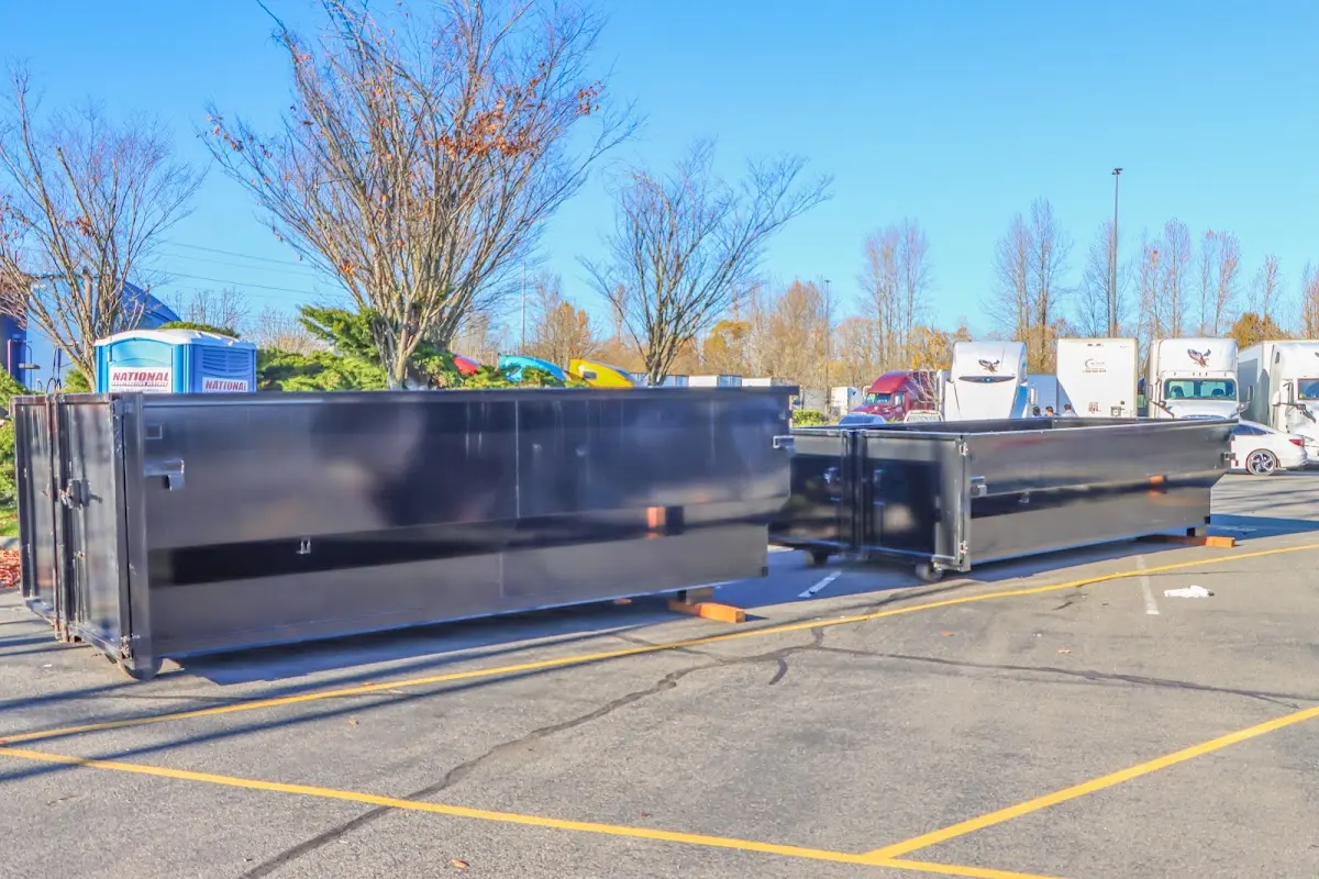 Professional dumpster rental service with roll-off container on residential driveway in Tarrytown